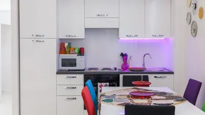 a kitchen with a table and a purple light at Rental in Rome Palermo apartment in Rome
