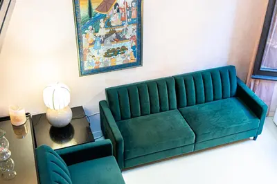 a green couch in a living room with a table at Rental in Rome Navona Loft in Rome
