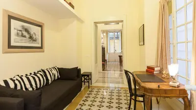 a living room with a couch and a table at Rental in Rome Ghetto Garden in Rome