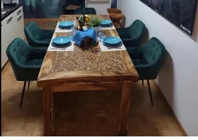 a wooden table with four green chairs around it at Apartment Rome 18 in Rome