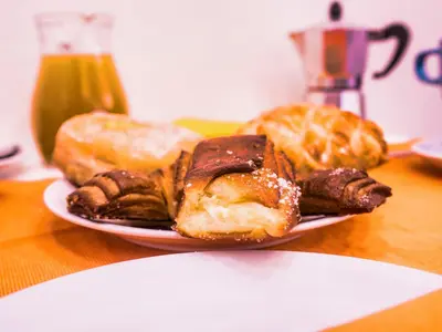 a plate of different types of pastries on a table at Ferrari al Vaticano in Rome