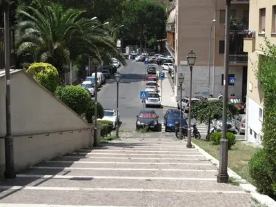 a sidewalk with cars parked on a street at Ferrari al Vaticano in Rome