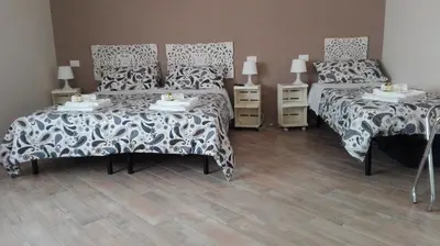 a bedroom with two beds and two night stands at My Sweet Rome Guest House in Rome