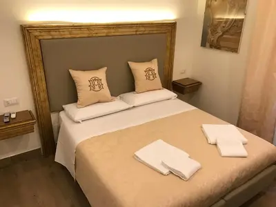 a bedroom with a large bed with white towels on it at Art Atelier Accomodation Guest House in Rome