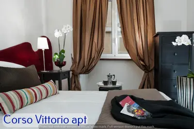 a bathroom with a sink and a toilet and a mirror at Corso Vittorio Apartments in Rome