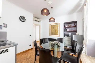 a bathroom with a sink and a vase of flowers at Corso Vittorio Apartments in Rome