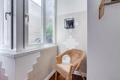 a wicker chair in a bathroom with a window at Appartamenti con vista Piazza Testaccio in Rome