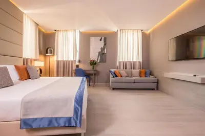 a bedroom with a bed and a flat screen tv at Orazio Palace Hotel in Rome
