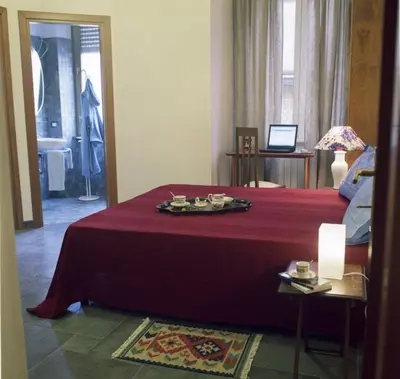 a hotel room with a bed with a red blanket at B&B Buongiornoroma in Rome