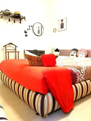 a bedroom with a bed with a red blanket on it at Festina Lente in Rome