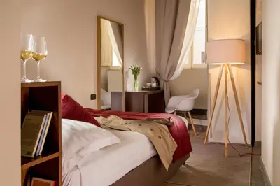 a bedroom with a bed with a mirror and a lamp at Palazzo Medusa in Rome