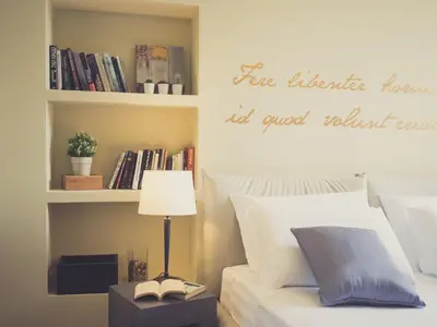 a bedroom with a bed and a book shelf with books at Domus Corsini in Rome