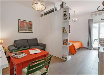 a living room with a couch and a table at L'Attichetto di Ponte Milvio a Roma Centro in Rome