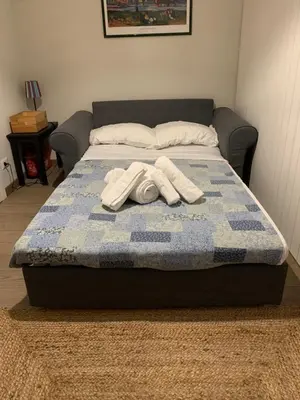 a bed with two white towels on top of it at L'Attichetto di Ponte Milvio a Roma Centro in Rome
