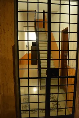 a view through a glass door into a room at L'Attichetto di Ponte Milvio a Roma Centro in Rome