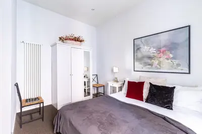 a bedroom with a bed and a painting on the wall at Monserrato Historical by Campo de' Fiori in Rome
