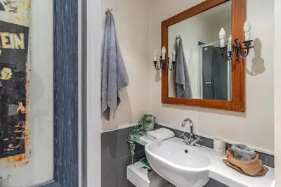 a bathroom with a sink and a mirror at Monserrato Historical by Campo de' Fiori in Rome