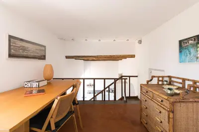 a room with a wooden desk and a table at Trastevere Charming Penthouse in Rome