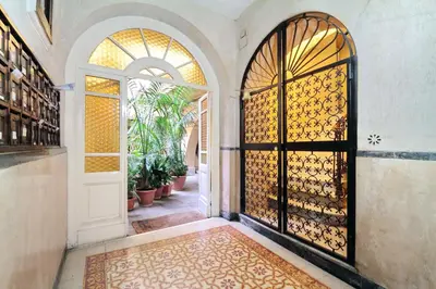 an entrance to a house with a door and a rug at Le 2 Basiliche - Esquilino Retreat in Rome