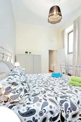 a bedroom with a large blue and white bed at Le 2 Basiliche - Esquilino Retreat in Rome