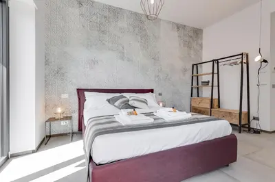 a bedroom with a bed with two towels on it at Rome as you feel - Vatican Terrace Apartments with View in Rome