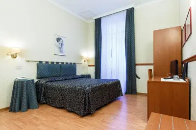a hotel room with a bed and a television at Hotel Paris in Rome