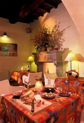 a living room with a table and a fireplace at Hotel Santa Maria in Rome