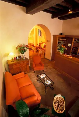 a living room with an orange couch and a table at Hotel Santa Maria in Rome