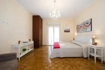 a living room with a bed and a couch at House Gregorio in Rome