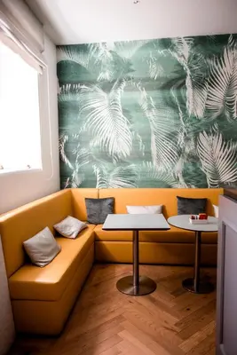 a yellow couch with a table in a room at Boutique Centrale Palace Hotel in Rome