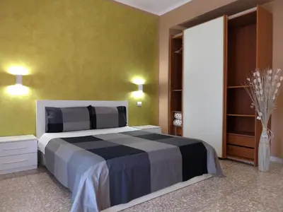 a bedroom with a large bed in a room at Roman Holidays House Marconi in Rome