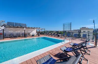 a swimming pool on the roof of a building at H10 Roma Città in Rome