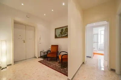 a hallway with a room with a table and chairs at EnzHouse in Rome