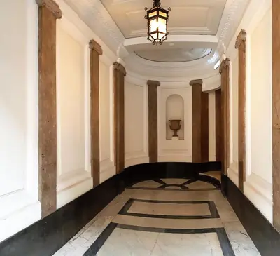 an empty hallway in a building with a chandelier at EnzHouse in Rome