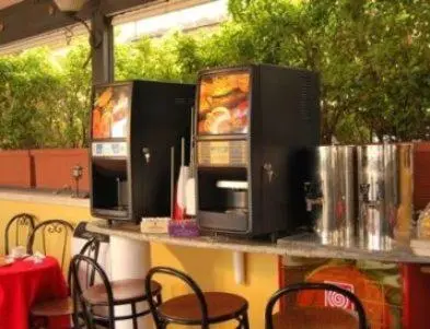 three microwaves on a table with tables and chairs at Hotel Nardizzi Americana in Rome