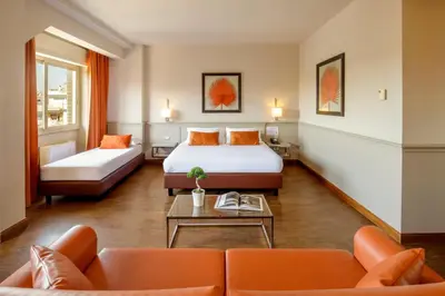 a hotel room with a bed and a couch at Grand Hotel Fleming by OMNIA hotels in Rome