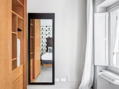 a mirror in a room with a bedroom at Numa Rome Vici in Rome