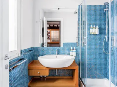 a bathroom with a sink and a shower at Numa Rome Vici in Rome