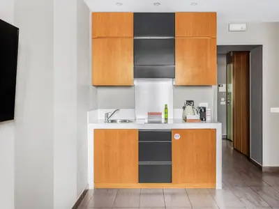 a kitchen with brown and white counters and cabinets at Numa Rome Vici in Rome
