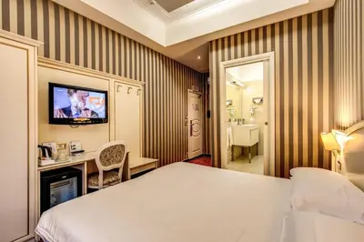 a hotel room with a bed and a bathroom at Trevi 41 Hotel in Rome