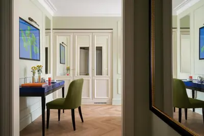 a dining room with a blue table and green chairs at Palazzo Ripetta in Rome