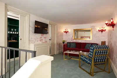 a living room with a red couch and a table at Palazzo Ripetta in Rome