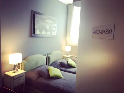 a small bedroom with a bed and a nightstand with a lamp at Caracalla Room Rental in Rome