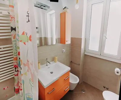 a bathroom with a sink and a toilet and a window at Casanova in Rome