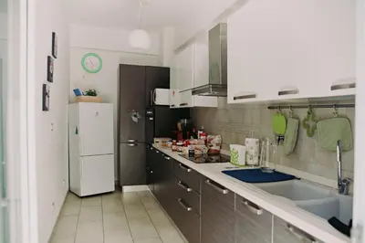 a kitchen with a white refrigerator and a sink at Casanova in Rome