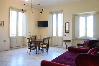 a living room with a table and chairs at Fontana Più Stella in Rome