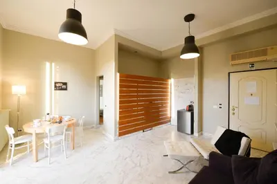 a living room with a table and a dining room at Fontana Più Stella in Rome