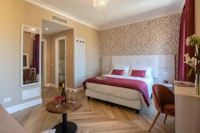 a bedroom with a bed and a table and a couch at The Boutique Hotel in Rome