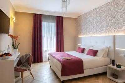 a bedroom with a bed and a table and a window at The Boutique Hotel in Rome