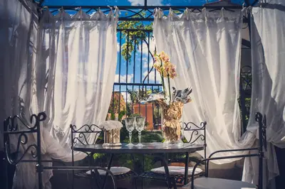 a table with glasses and a vase with flowers at Hotel Antica Locanda in Rome